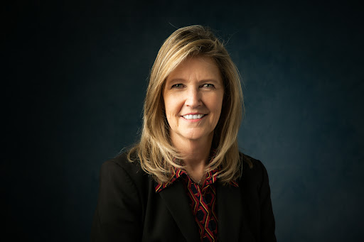 Headshot example photo of a woman against a dark studio background